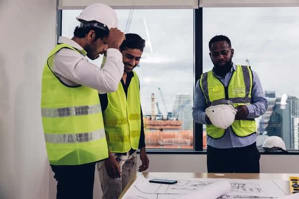 Team Engineers with draft plan of building on constructing site. Engineer work on site. engineer visit and inspection site engineer. Inspector engineer check and working on site.