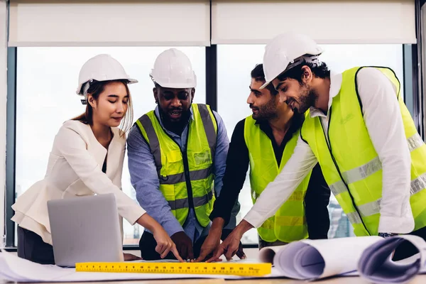 Team Engineers with draft plan of building on constructing site. Engineer work on site. engineer visit and inspection site engineer. Inspector engineer check and working on site.