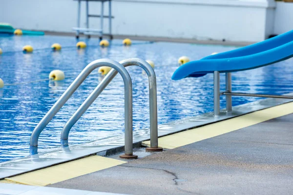 stock image Ladder stainless handrails for descent into swimming pool. Swimming pool with handrail . Ladder of a swimming pool. Horizontal shot. stairs swimming pool. Stainless steel ladder