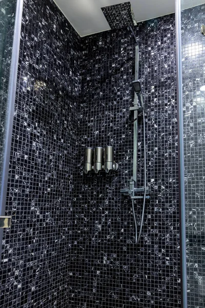 Shower at bathroom. Bathroom interior . Luxury fully tiled shower with rain head and hand held shower rose.	