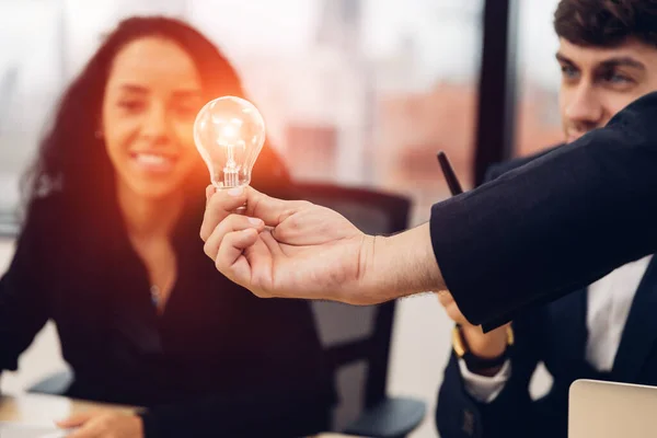 Businessman holding light bulb. Idea concept with innovation and inspiration.  businessman holding illuminated light bulb. Brain creative thinking ideas and innovation concept.