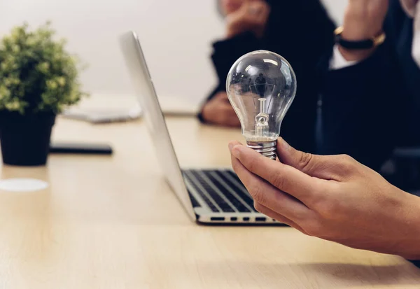 stock image Businessman holding light bulb. Idea concept with innovation and inspiration.  businessman holding illuminated light bulb. Brain creative thinking ideas and innovation concept.