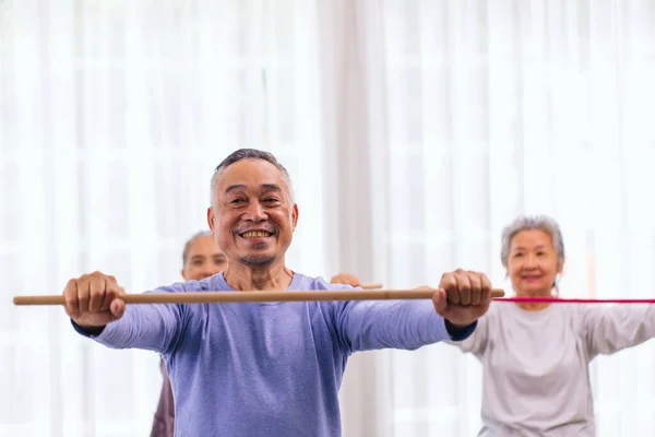 stock image Seniors stretching exercise together at retirement center. Old people exercise at home. Retired Person exercising at nursing home. Active seniors exercising in home. Sport and recreation concept.