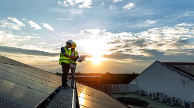 Engineer working setup Solar panel at the roof top. Engineer or worker work on solar panels or solar cells on the roof of business building