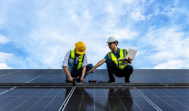 Engineer working setup Solar panel at the roof top. Engineer or worker work on solar panels or solar cells on the roof of business building