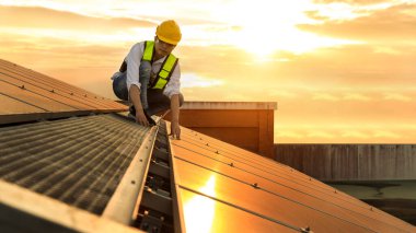 Engineer working setup Solar panel at the roof top. Engineer or worker work on solar panels or solar cells on the roof of business building clipart