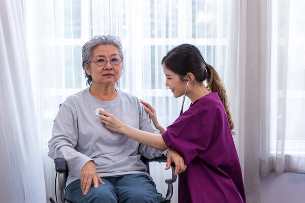 Caregiver nurse take care a Senior patient walking in park. Nurse helping senior Woman	