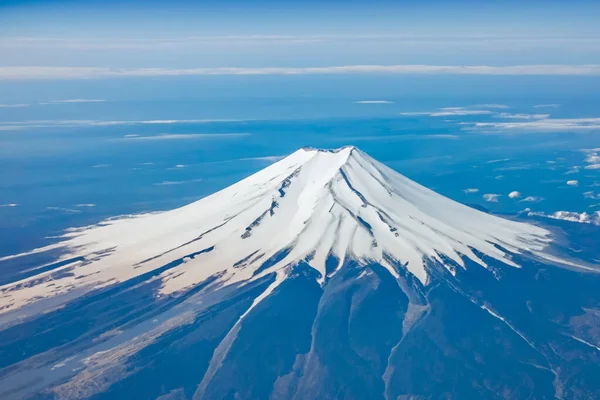 stock image Top view of the Japan icon Mt Fuji from the airplane. Mt. Fuji seen from the window of an airplane. bird eye view of fuji mountain, famous volcano in japan, shot from airplane window.