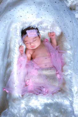 Yeni doğan uyuyor. Yeni doğmuş bebekler yatakta uyur. Yeni doğan bebeklerin yatakta güzel bir uykusu var. Sevimli ikiz bebek evde çekim yapıyor. bebek ve ailenin moda imajı. 