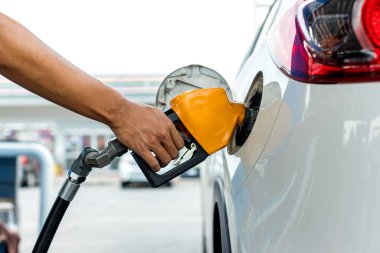 Man Refill and filling Oil Gas Fuel at station. Gas station - refueling. To fill the machine with fuel. Car fill with gasoline at a gas station. Gas station pump.	