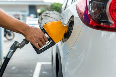 Man Refill and filling Oil Gas Fuel at station. Gas station - refueling. To fill the machine with fuel. Car fill with gasoline at a gas station. Gas station pump.	
