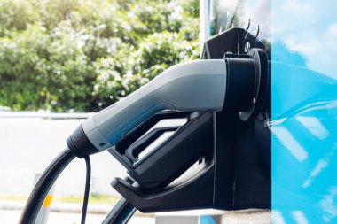 Elektrikli araba şarj istasyonu. Otoparktaki hibrit araba elektrik şarj istasyonu. Elektrikli araba park ve şarj istasyonunda şarj oluyor. Elektrik prizi. Ulaşım EV