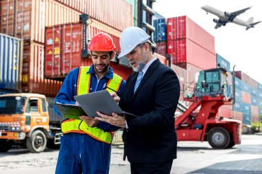 Foreman or worker work at Container cargo site check up goods in container. Foreman or worker checking on shipping containers. Logistics and shipping.	