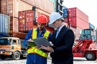 Foreman or worker work at Container cargo site check up goods in container. Foreman or worker checking on shipping containers. Logistics and shipping.	