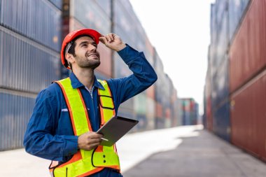Foreman or worker work at Container cargo site check up goods in container. Foreman or worker checking on shipping containers. Logistics and shipping.	