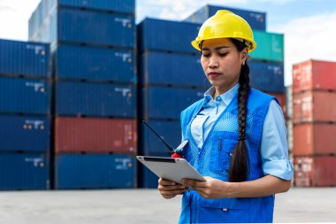 Foreman or worker work at Container cargo site check up goods in container. Foreman or worker checking on shipping containers. Logistics and shipping.	