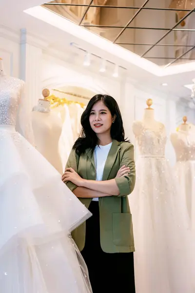 Female bridal store owner work in wedding studio shop. Owner Of Bridal Wedding Dress Shop Work in shop. Designer woman working wedding dress in store.