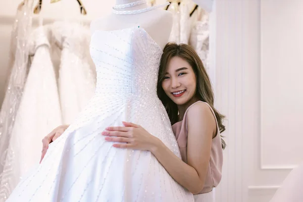 Bride and groom wear dress and try to fitting in wedding studio