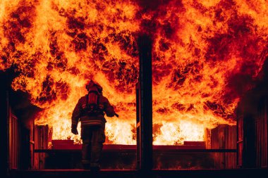 Firefighter Concept. Fireman using water and extinguisher to fighting with fire flame. firefighters fighting a fire with a hose and water during a firefighting training exercise