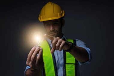 Engineering holding light bulb. Idea concept with innovation and inspiration. Engineering  holding illuminated light bulb. Brain creative thinking ideas and innovation concept.	