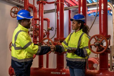 Engineer or technician work checking Fire suppression system and fire equipment. Engineer check red generator pump for water sprinkler piping and fire alarm control system