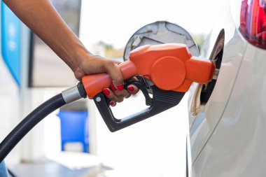 Man Refill and filling Oil Gas Fuel at station. Gas station - refueling. To fill the machine with fuel. Car fill with gasoline at a gas station. Gas station pump.	