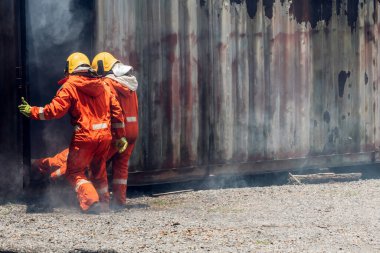 First aid support accident at work. Firefighter to save girl in fire and smoke. Rescue Team or Firefighters save lives people from fire. Firefighter or Emergency team rescue saving life people	