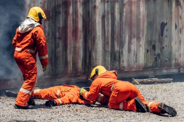 First aid support accident at work. Firefighter to save girl in fire and smoke. Rescue Team or Firefighters save lives people from fire. Firefighter or Emergency team rescue saving life people	