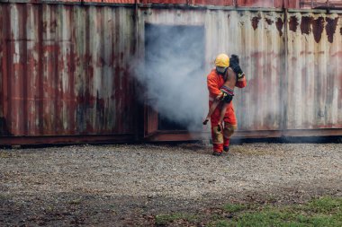 Firefighter to save girl in fire and smoke. Rescue Team or Firefighters save lives people from fire. Firefighter or Emergency team rescue saving life people from fire	