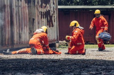 First aid support accident at work. Firefighter to save girl in fire and smoke. Rescue Team or Firefighters save lives people from fire. Firefighter or Emergency team rescue saving life people	