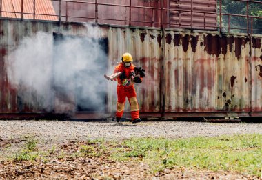 Firefighter to save girl in fire and smoke. Rescue Team or Firefighters save lives people from fire. Firefighter or Emergency team rescue saving life people from fire	