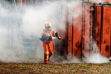 Firefighter to save girl in fire and smoke. Rescue Team or Firefighters save lives people from fire. Firefighter or Emergency team rescue saving life people from fire	
