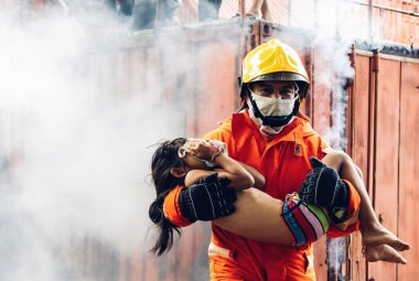 Firefighter to save girl in fire and smoke. Rescue Team or Firefighters save lives people from fire. Firefighter or Emergency team rescue saving life people from fire	