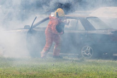 Firefighter to save girl in fire and smoke. Rescue Team or Firefighters save lives people from fire. Firefighter or Emergency team rescue saving life people from fire	