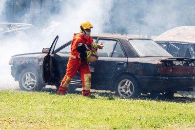Firefighter to save girl in fire and smoke. Rescue Team or Firefighters save lives people from fire. Firefighter or Emergency team rescue saving life people from fire	