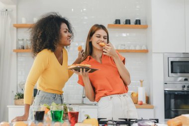 Gururlu LGBT Ailesi mutfakta, gülen surat. Evde aile yemeği hazırlıyorum. Mutlu gülümseyen aile mutfakta birlikte yemek yaparken eğleniyor. Aile hayatı. Birlikte mutluyuz, mutfakta yemek yapıyoruz..