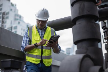 Industrial engineer work on site. engineer visit and inspection site engineer at industrial site. Inspector engineer check and working on site