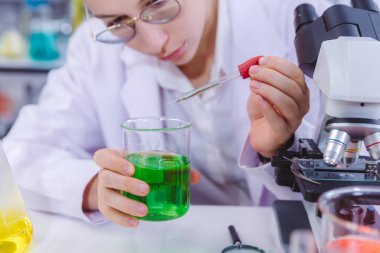 Bilimadamı ve bilim sınavındaki insanlar, deney ya da laboratuvar ödevi için test ya da grup projesi. Bilim laboratuarında çalışan bilim adamı ya da eczacı. Tıbbi Geliştirme Laboratuarı. 