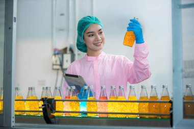 Worker Checking quality or checking stock of glass bottle in beverage factory. Worker QC working in a drink water factory 