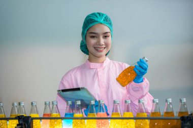 Worker Checking quality or checking stock of glass bottle in beverage factory. Worker QC working in a drink water factory 