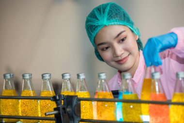 Worker Checking quality or checking stock of glass bottle in beverage factory. Worker QC working in a drink water factory 
