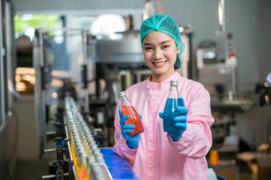 Worker Checking quality or checking stock of glass bottle in beverage factory. Worker QC working in a drink water factory 