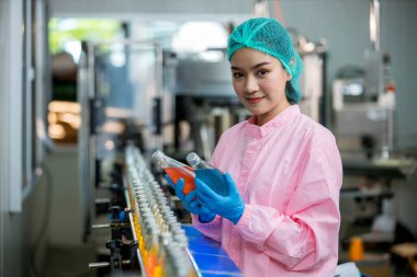 Worker Checking quality or checking stock of glass bottle in beverage factory. Worker QC working in a drink water factory 