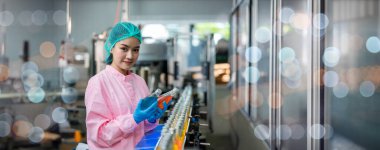 Worker Checking quality or checking stock of glass bottle in beverage factory. Worker QC working in a drink water factory 