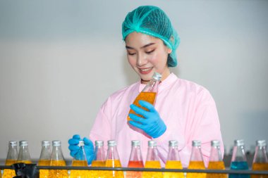 Worker Checking quality or checking stock of glass bottle in beverage factory. Worker QC working in a drink water factory 