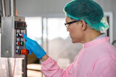 Worker Checking quality or checking stock of glass bottle in beverage factory. Worker QC working in a drink water factory 