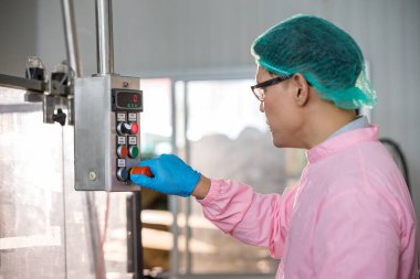 Worker Checking quality or checking stock of glass bottle in beverage factory. Worker QC working in a drink water factory 
