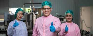 Worker Checking quality or checking stock of glass bottle in beverage factory. Worker QC working in a drink water factory 