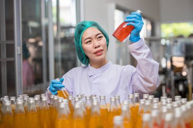 Worker Checking quality or checking stock of glass bottle in beverage factory. Worker QC working in a drink water factory 