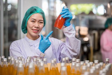 Worker Checking quality or checking stock of glass bottle in beverage factory. Worker QC working in a drink water factory 